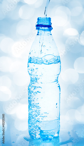 Photo: pouring water from bottle pouring water from bottle