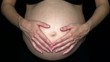 Pregnant woman stroking her belly