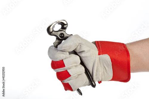 Photo: Hand with protection glove holding pincer Hand with protection glove holding pincer