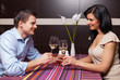 Young couple drinking wine and flirting