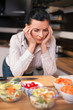 Foto: Depressed young woman in kitchen Depressed young woman in kitchen