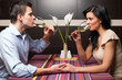 Photo: Young couple drinking wine and flirting Young couple drinking wine and flirting