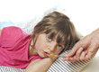 little girl taking cough syrup