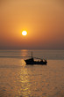 Photo: Sunset over the ocean with a boat Sunset over the ocean with a boat