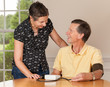 Foto: Senior man taking blood pressure with wife Senior man taking blood pressure with wife