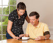 Foto: Senior man taking blood pressure with wife Senior man taking blood pressure with wife
