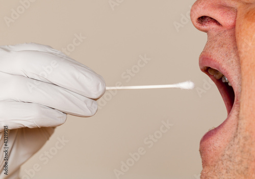 Photo: DNA swab of saliva taken from senior man DNA swab of saliva taken from senior man