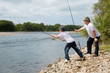 Grandfather and grandson fishing