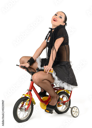 Foto: Beautiful french maid, at the children's bicycle Beautiful french maid, at the children's bicycle