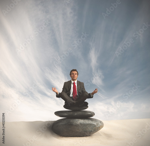 Photo: Business man relaxes on the stone Business man relaxes on the stone