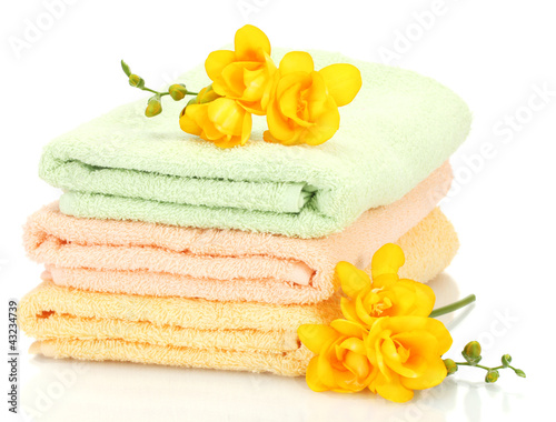 Photo: colorful towels and flowers isolated on white colorful towels and flowers isolated on white
