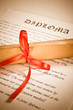 Diploma with red ribbon