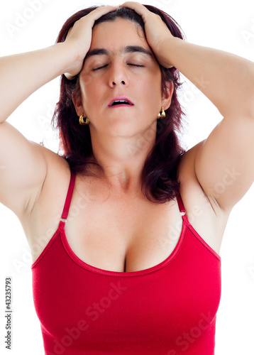 Photo: Very stressed hispanic woman with a headache isolated on white Very stressed hispanic woman with a headache isolated on white