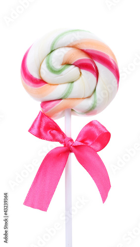 Photo: Colorful lollipop with bow isolated on white Colorful lollipop with bow isolated on white