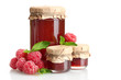 jars with jam and ripe raspberries with mint isolated on white