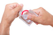 man is opening a condom, isolated on white