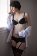 Pretty brunnete looking throught the window in lingerie