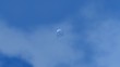 Plain glass of water falling from a blue sky .