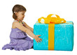 Girl with a big gift box on white background