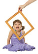Happy little girl looking through the frame