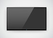 Black LCD or LED tv screen hanging on a wall