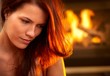 Portrait of attractive woman in front of fire