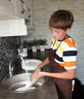 boy doing the dishes