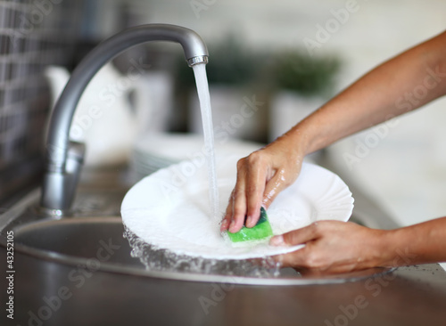 Photo: Cleaning dishware kitchen sink sponge washing dish Cleaning dishware kitchen sink sponge washing dish