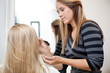 Artist Applying Make Up To Woman