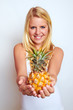 Foto: young blond woman with a fresh pineapple young blond woman with a fresh pineapple