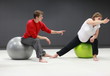 pregnant woman with  personal trainer on large  stability balls