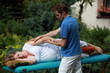 Physical therapist massaging pregnant woman's arm