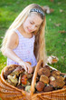 a girl with a basket filled with mushrooms