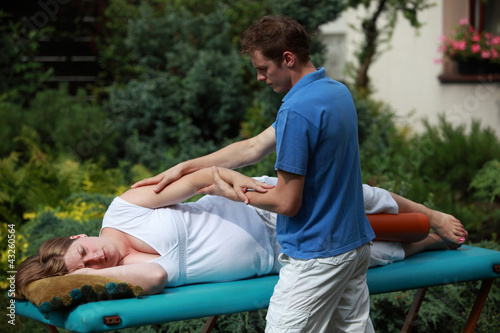 Photo: Physical therapist massaging pregnant woman's arm Physical therapist massaging pregnant woman's arm