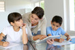 Photo: Woman teaching class to school children with digital tablet Woman teaching class to school children with digital tablet