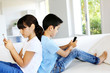 Kids playing at home with smartphones