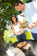 Couple cooking meat on barbecue grill