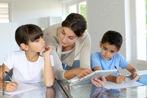 Photo: Woman teaching class to school children with digital tablet Woman teaching class to school children with digital tablet