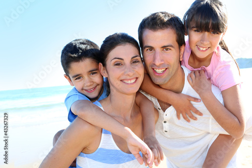 Photo: Closeup of happy family at the beach Closeup of happy family at the beach