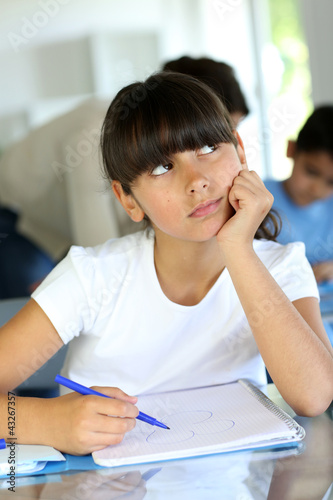 Foto: Young school girl with bored look on her face Young school girl with bored look on her face