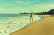 girl jogging running barefoot on the sand at the beach