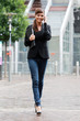 Photo: Femme d'affaire arrivant au bureau au téléphone Femme d'affaire arrivant au bureau au téléphone
