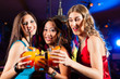 People drinking cocktails in bar or club
