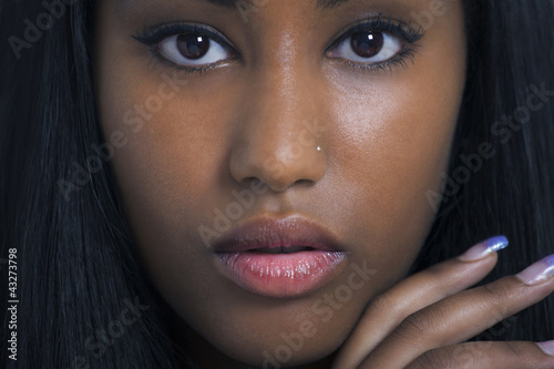 Photo: Lovely ethnic woman face closeup Lovely ethnic woman face closeup
