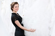 Shop assistant  is looking for dress for the bride