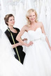 Seamstress measures waist of the dissatisfied bride