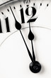 Clock hands almost twelve zoom in