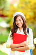 Young woman student in autumn park