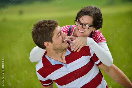 Photo: Portrait of romantic young couple smiling together outdoor Portrait of romantic young couple smiling together outdoor