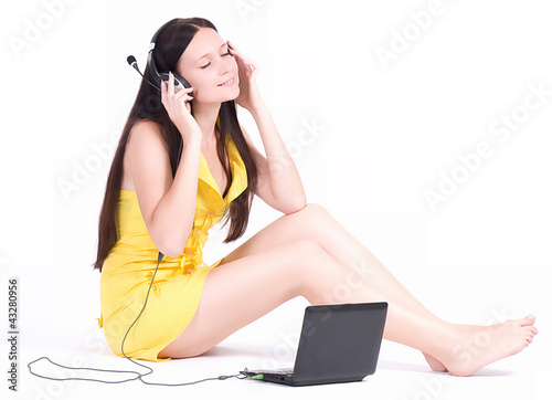 Photo: Teenage girl listen the music with computers PC Teenage girl listen the music with computers PC